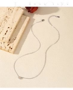 Detailed view of silver necklace with oval champagne stone pendant and lobster clasp