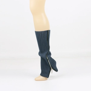 Close-up of navy blue knitted leg warmers featuring a sleek silver side zipper design