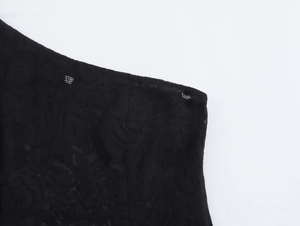 Detailed view of floral lace pattern on the black off-shoulder evening dress