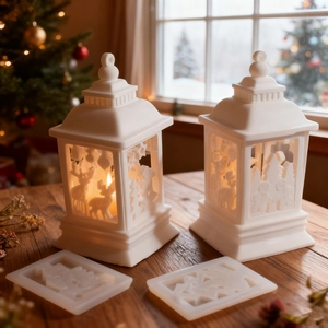 Macro view of white resin Christmas lantern molds with reindeer and snowflake cutout details