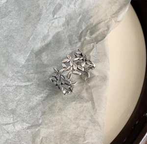 Detailed macro of vintage S925 sterling silver ring featuring hollow leaf textures