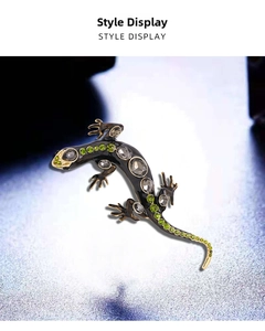 Close-up of lizard brooch with green and grey rhinestones on black plated alloy base