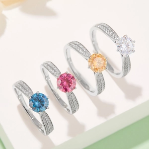 Macro detail of colorful S925 silver moissanite rings in blue, pink, and yellow options