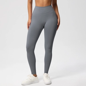Detailed close-up of high-waisted seamless grey yoga leggings with wide waistband texture