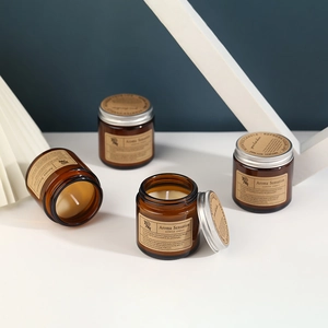 Set of four amber glass scented soy candles with silver metal lids and kraft labels