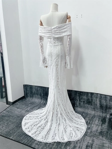 Back view of elegant white lace off-shoulder gown featuring flared sleeves and a long train