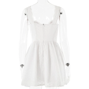 Close-up of white lace embroidery and invisible zipper on the back of the A-line dress