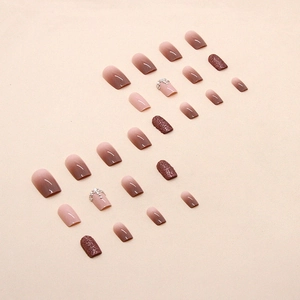 Gradient brown and pink press-on nails with sparkling rhinestones and pearl accents