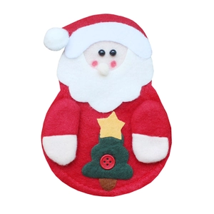 Detail of felt Santa Claus cutlery holder with green tree and red button decoration