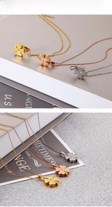 Detail of frosted four-leaf clover pendant in gold, rose gold and silver stainless steel