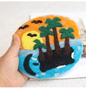 Handmade wool felt coaster featuring a sunset island scene with coconut trees