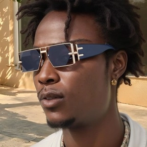 Detail of trendy polygonal sunglasses featuring T-shape metal hinge and gold accents