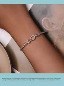 Detail of 925 silver infinity heart bracelet with twisted rope chain on skin
