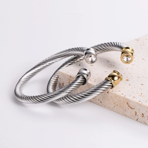 Two-tone stainless steel cable wire cuff bracelet featuring clear cubic zirconia stones