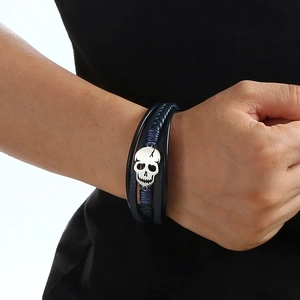 Men's punk braided leather bracelet with silver skull charm on a blue woven rope band