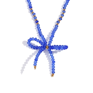 Royal blue faceted crystal bead necklace with gold accents and elegant bow pendant