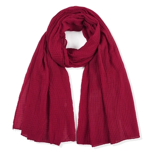 Deep red wrinkled cotton linen rectangular scarf draped on a clean white background