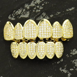 Iced out hip hop grillz set in gold plating with micro paved cubic zirconia stones