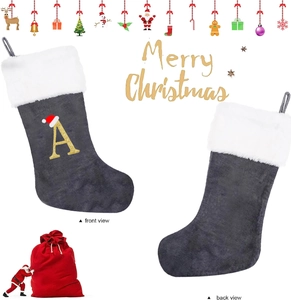 Detail of grey velvet Christmas stocking with gold letter A embroidery and plush white cuff