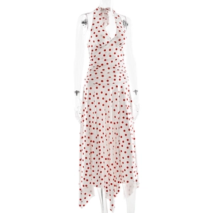 Detail of white halter neck dress with red polka dots and irregular hem on mannequin
