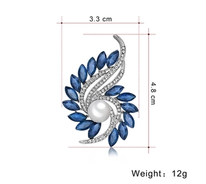 Detailed view of blue gemstone and pearl flower brooch with 3.3cm by 4.8cm dimensions
