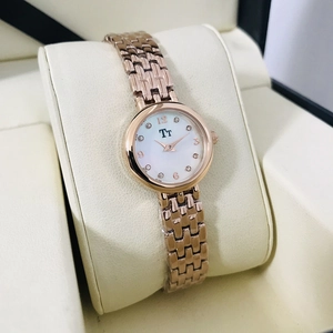 Detailed macro view of a rose gold quartz watch with rhinestones in an elegant gift box