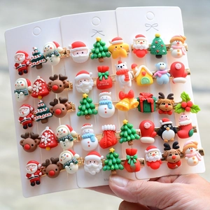 Set of colorful Christmas hair clips with Santa, reindeer, and tree designs on card
