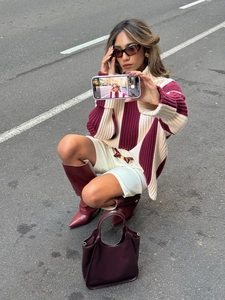 Chic burgundy and cream color-block turtleneck knit sweater with striped sleeves