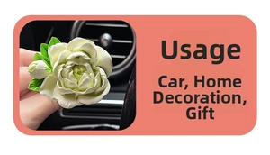 Detailed close-up of white jasmine flower diffuser clip on car air vent outlet