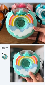 Detail view of Macarone blue donut-shaped water bottle with rainbow patterns and strap
