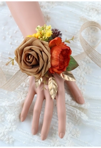 Detail of vintage wrist corsage with rose, peony and burlap ribbon on a lace background