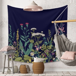 Detail of dark blue botanical tapestry with colorful floral prints in a cozy home setting