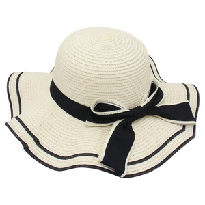 Elegant wide brim straw sun hat with black ribbon bow and wavy contrast edge