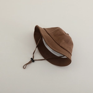 Detail of brown cotton baby bucket hat with adjustable chin strap and soft inner lining