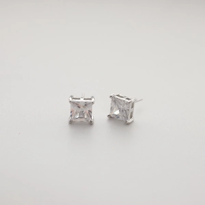 Macro shot of 925 silver princess cut zircon stud earrings with four-claw setting