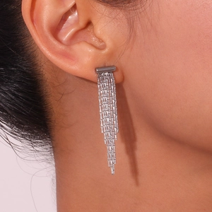 Silver stainless steel chain tassel earrings with T-bar drop shown on a model