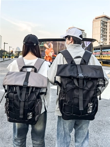 Large capacity basketball backpack with roll-top design and mesh pocket shown on model