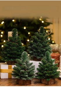 Mini artificial pine Christmas trees with wooden bases and pinecones on gift boxes