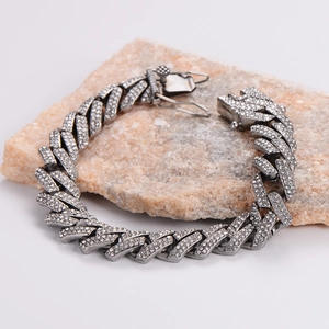 Heavy metal Cuban link necklace with sparkling crystals on natural stone background