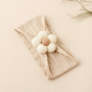 Detail of baby nylon headband with knit floral pattern and soft 3D flower decoration