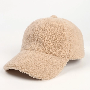 Close-up detail of beige lamb wool texture and stitching on the warm baseball cap