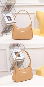 Close-up of lychee pattern shoulder bag featuring golden metal plate and leaf pendant