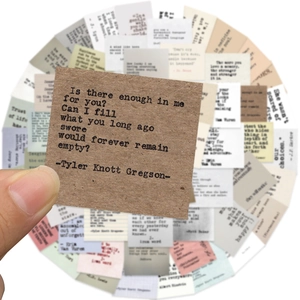 Detail of vintage typewriter style inspirational quote stickers on kraft and ivory paper