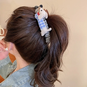 Close-up of cute fabric dachshund hair clip with blue plaid outfit on hair