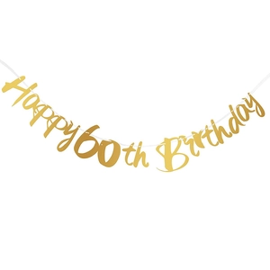 Detail of shimmering gold 60th Birthday party banner hanging on white background