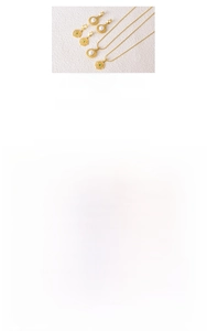 Detail view of 18k gold plated titanium jewelry set with green agate and pearl charms