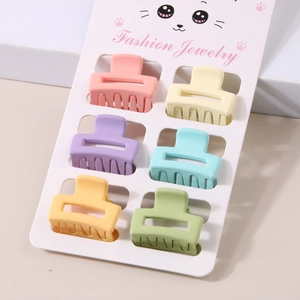Detail of six pastel macaron hair claws in square design on a display card