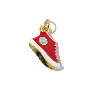 Macro detail of red enamel canvas sneaker charm with gold-plated metal accents