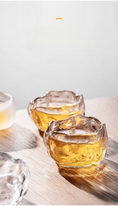 Detail of handcrafted ice-crackled crystal glass tea cup with textured glass surface