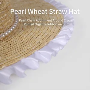 Straw sun hat for women with white lace trim and elegant pearl chain decoration
